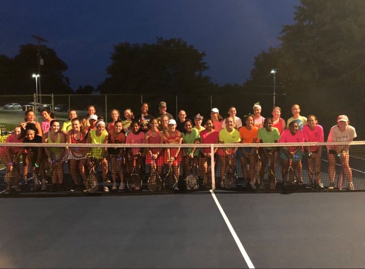 The+girls+tennis+team+really+glows+all+out+during+their+preseason.+Dressed+in+neon+gear%2C+the+team+practiced+in+the+dark+for+a+glow+theme+practice.+