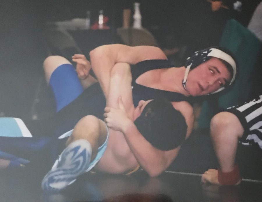 Tucker taking down his opponent back in his high school days. His love of the sport followed him from high school, into college, and now to his career at Seton Hill University. 
