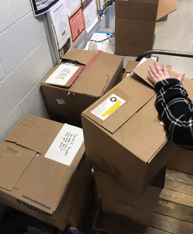 The boxes filled with snacks, games, letters, and more for the soldiers during the holiday season. This is some of the 114 boxes sent. 