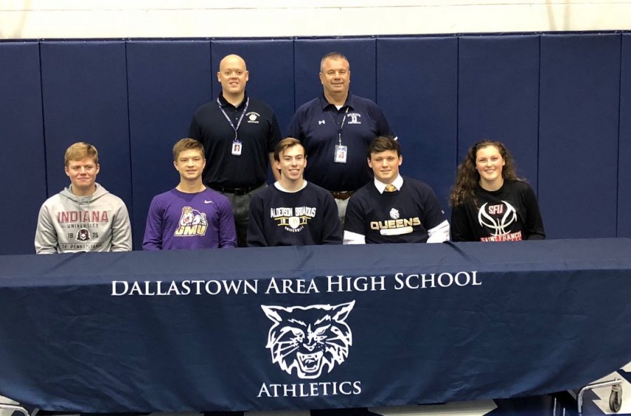 On the first signing day of the year, 5 DT student-athletes signed their NLI. Pictured are the athletes with High School Principal Dr. Fletcher (left) and Athletic Director Mr. Sortino (right)