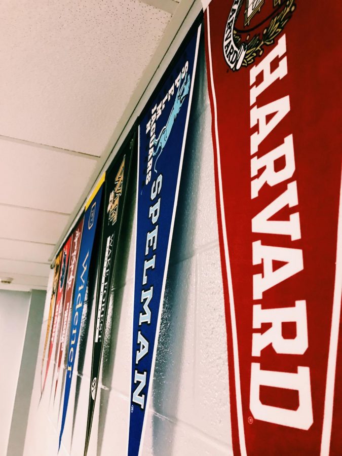 Flags hung up outside guidance office, promoting the different colleges. 