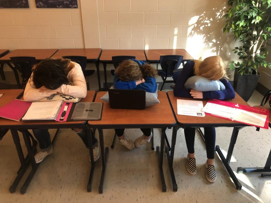 Three Dallastown students lay sleepily on their desks on an early school morning. 