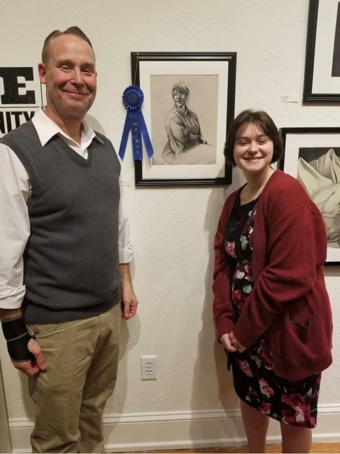 Sophomore Libby Fullam and Dallastown art teacher Mr. Myers beside winning pencil sketch Untitled.