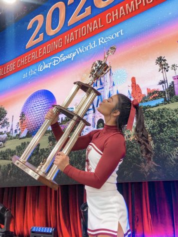 Helmer holds the first place trophy after Alabamas all-girl cheer team won the Division 1A National Champion title. The All-Girl cheer team is coached by Brandon Prince and Jennifer Thrasher, director of spirit programs at University of Alabama.