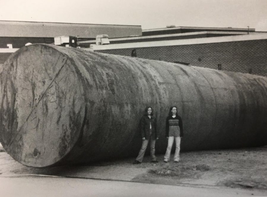 Students pose next to a tank that was unearthed to revamp the system that fueled the middle and high school. Prior to the 1998-2001 construction, the school was not air conditioned. 