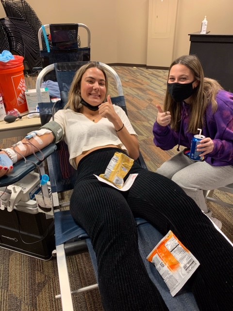 Senior Chase Curran (left) gets some support from senior Aiden Lese as they participate in this years blood drive at Living Word Church on Jan. 18. 
