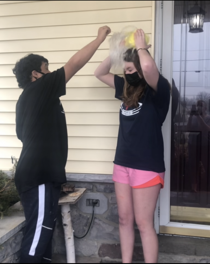 Dallastown senior, Katie Queenan, has her friend Michael pop a cold water balloon over her head. This was to raise money for local schools to start unified programs.