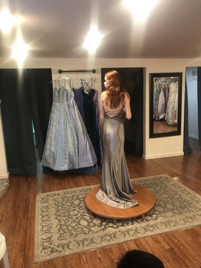 Senior Emily Dias shops for dresses for Dallastowns formal senior banquet at Lillas Bridal Boutique. Although it isnt officially being called a prom, students are still encouraged to dress in semi-formal to formal attire. 
