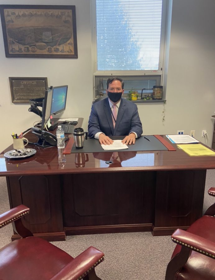 Dallastown super intendent, Dr.Doll, sitting at his desk. He believes in balance and that there is benefits to having both virtual snow days and traditional snow days.