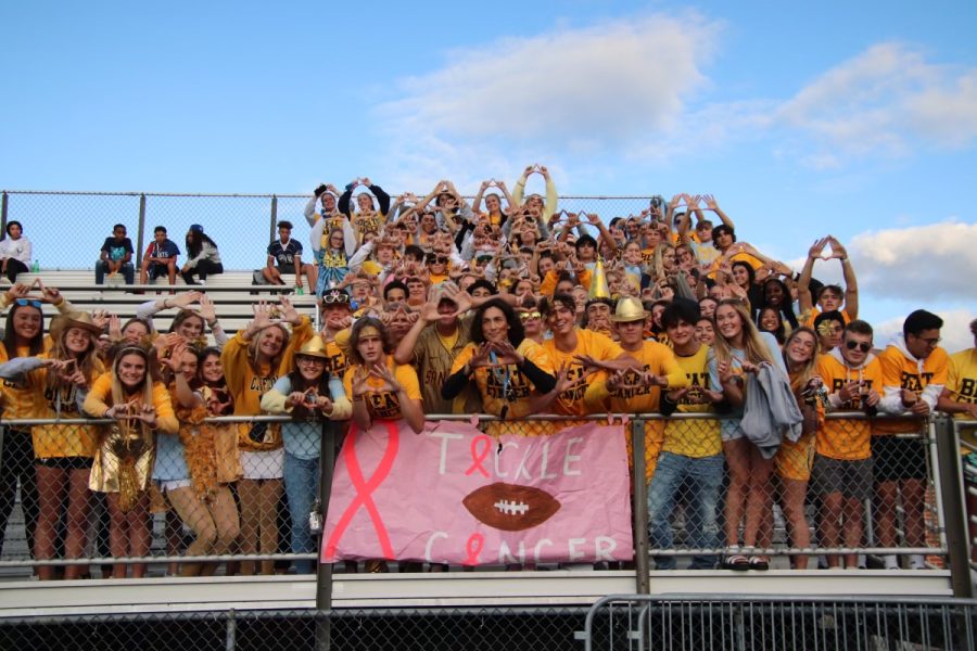The Special Events and Fundraising Committee organize a Beat Cancer Football game each year. Pictured here the student section is holding up the Four Diamonds symbol For The Kids.
