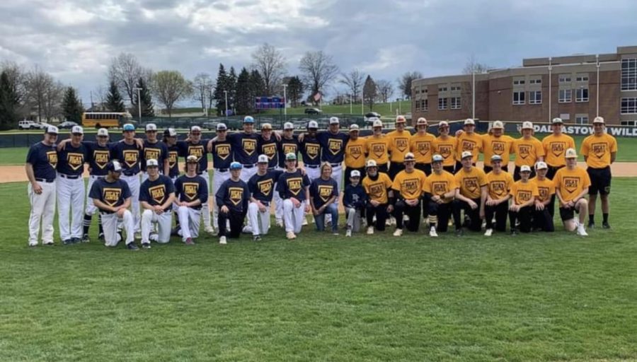 The+Dallastown+and+Red+Lion+baseball+teams+take+a+picture+together+before+the+April+14+game%2C+showing+off+their+Beat+Cancer+shirts+customized+for+the+fundraising+event.+