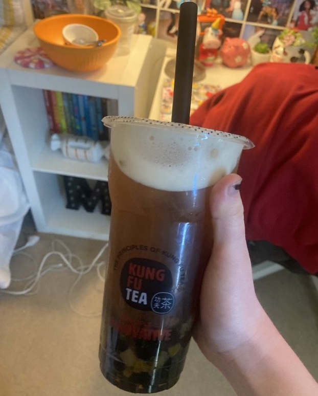 Meghan Kelly, a frequent customer at Kung Fu Tea, has a go-to order of peach oolong tea with tapioca pearls. Possible drink sizes include medium and large.