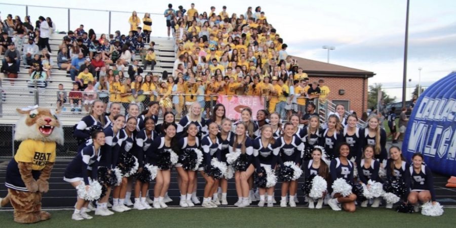 Dallastown Varsity Cheerleading posing for a picture in front of the student section during the Beat Cancer game. 