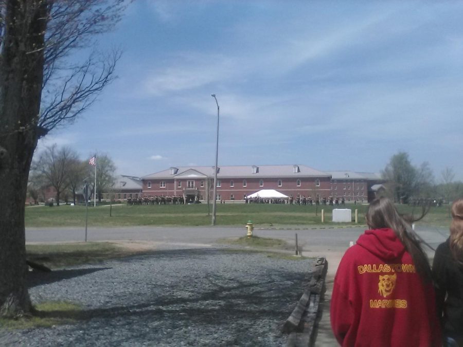 The Dallastown MCJROTC cadets (right) passing by a battalion of Marines (in the back) practicing military Drill at the Marine Corps Quantico Base, Virginia.