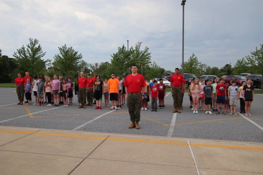 The+DAIS+fifth+graders+and+MCJROTC+cadets+assembled+as+a+unit+to+practice+drill+together.