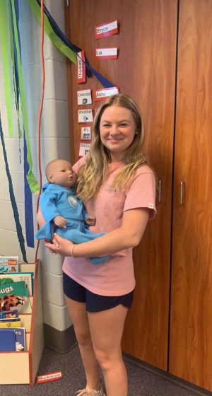 Here is Maddie Dewees Holding the RealCare baby in the child care class