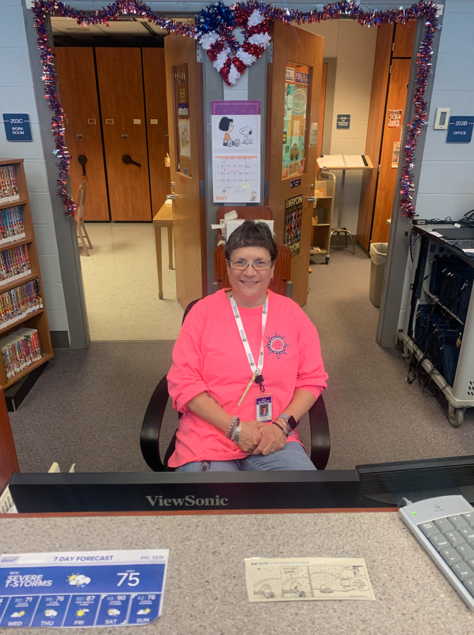 Dallastown+High+School+head+librarian+Mrs.+Karen+Dressel+sits+behind+the+circulation+desk+ready+to+help+students+research+or+find+books+they+love.+Dressel+says+that+is+her+favorite+part+of+her+job.+