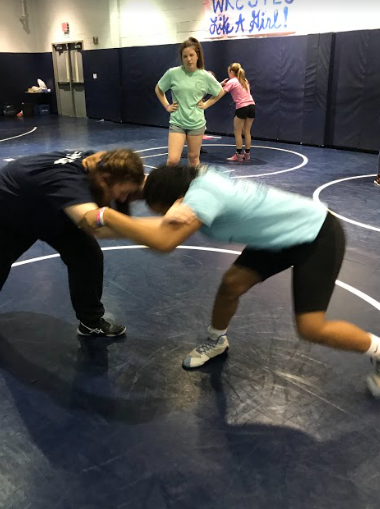 Abney (right) mid-action in a drill at the Girls Try Wrestling Night.