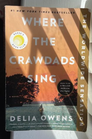 Paper copy of the novel Where the Crawdads Sing featuring the Reese Witherspoon book club stamp.