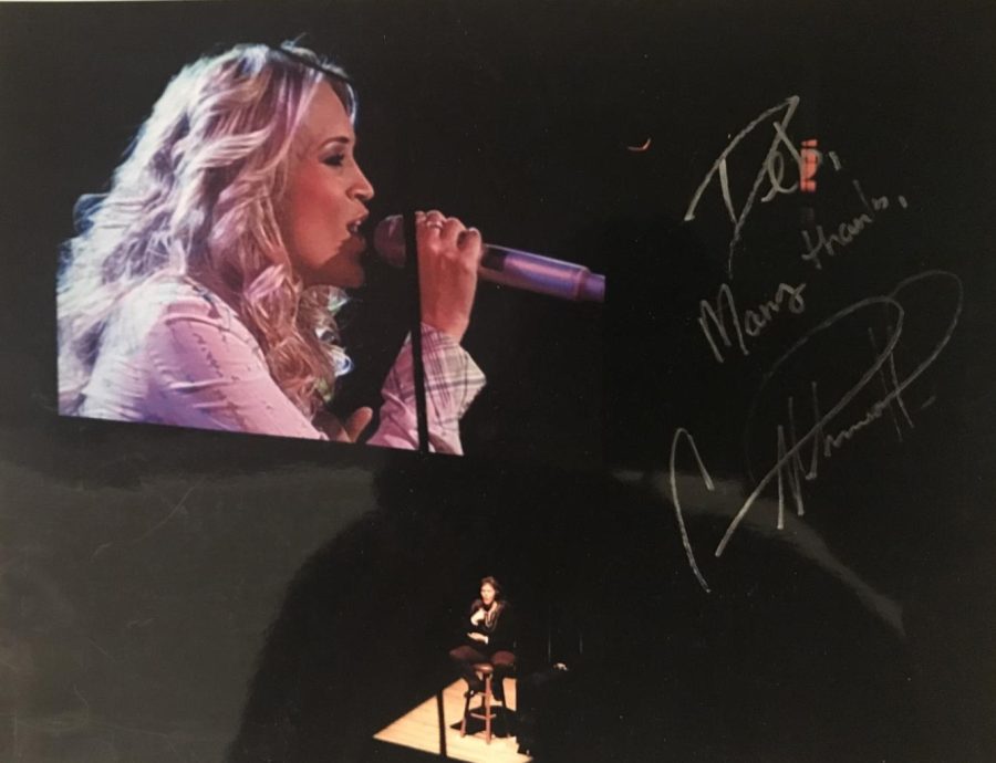 An autographed photo from Carrie Underwood featuring Moul at the bottom. 