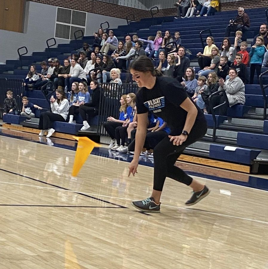 Ms. Reynolds, representing the middle school teachers, flips the cone to get her team the first win in the second round of the Battle of the Buildings. 