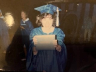 High school teacher and graduate of Class of 1986, Mrs. Dallmeyer after she receives her diploma from graduation.