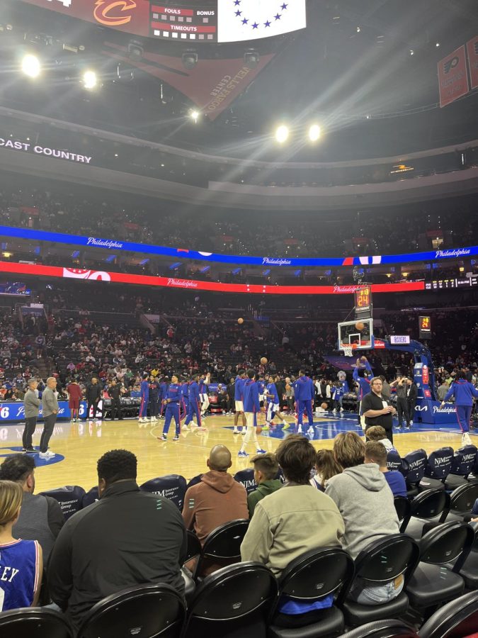 My family and I watching the Sixers basketball team warm up to play a game against the Cleveland Cavaliers. 