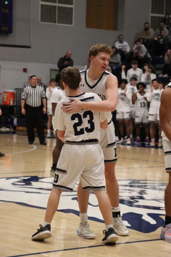 Jonah Stefko celebrating with his team Conner Barto after opening basket.  

