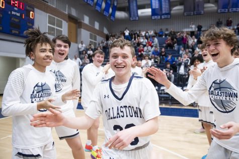 Dallastown senior Jonah Stefko smiles as his teammates cheer him on during the starting lineup introductions