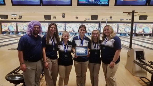 The girls' varsity team pose with their second-place medals and plaque after having a qualifying score of 1879 in the finals. Left to right: Coach Zelger, Eve Peters, Maddie Berkley, Mckenzie Geary, Kassie Vasellas, Reese Forella.