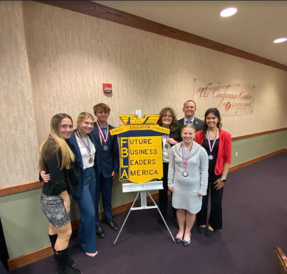 The Officers of FBLA in front of the FBLA sign