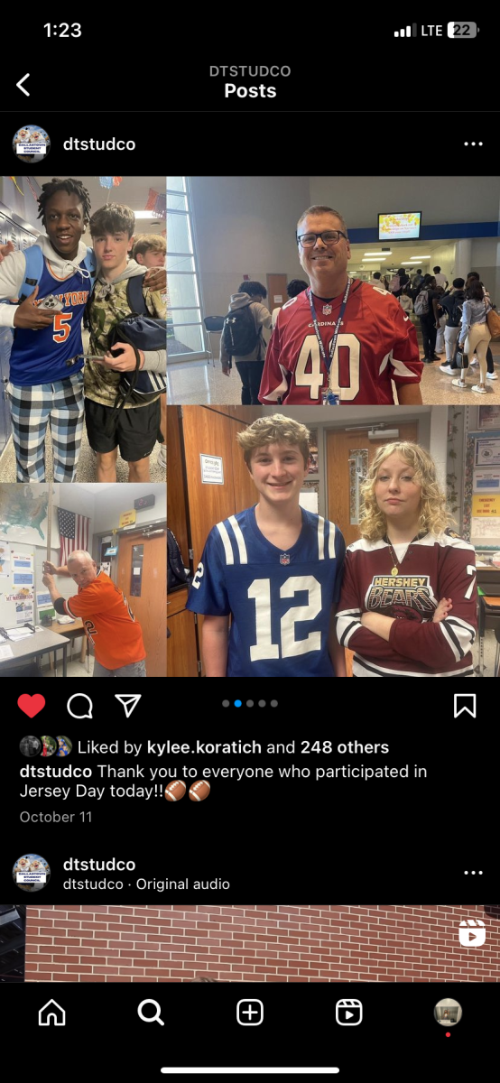 These students and staff posed for pictures while wearing different sport team jerseys.