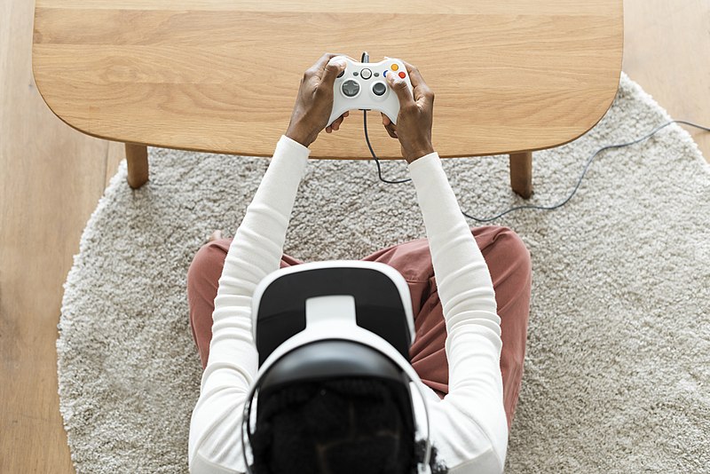 A man wearing a vr headset playing a game.