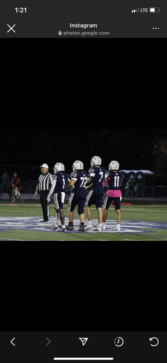 The team captains for the Homecoming game walk to the middle of the field for the coin toss. 