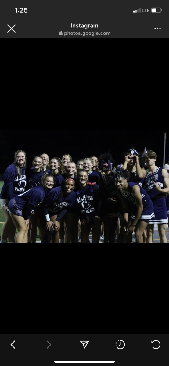 The upper classman team and the cheerleaders pose for a picture after the Powder Puff game. 