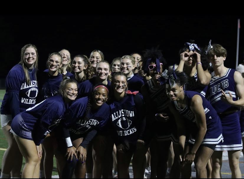 The upper classman team and the cheerleaders pose for a picture after the Powder Puff game. 