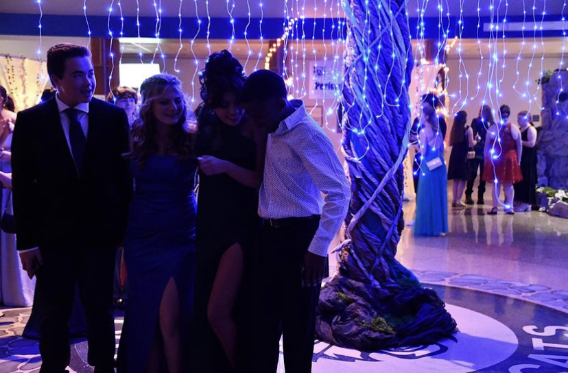 Students took many pictures during the 2023 Homecoming dance. One of the more popular backgrounds was the enchanted tree, located in the middle of the lobby. 
