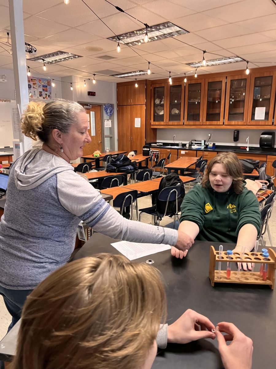 Fishel works with biology students on a lab in her classroom. 