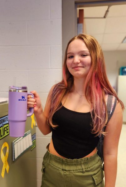 Sophomore Larissa Swisher poses with her purple Stanley Cup. Larissa first bought her Stanley for the aesthetic, but feels that any other cheaper cup would also do just fine. 