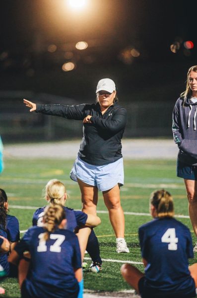 Coach Morgan White talks to the varsity team at half time of the Dallastown vs. Red Lion game.