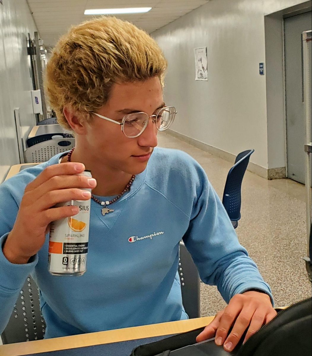 Junior Reuben Hughes drinks a Celsius while working on homework during his study hall.