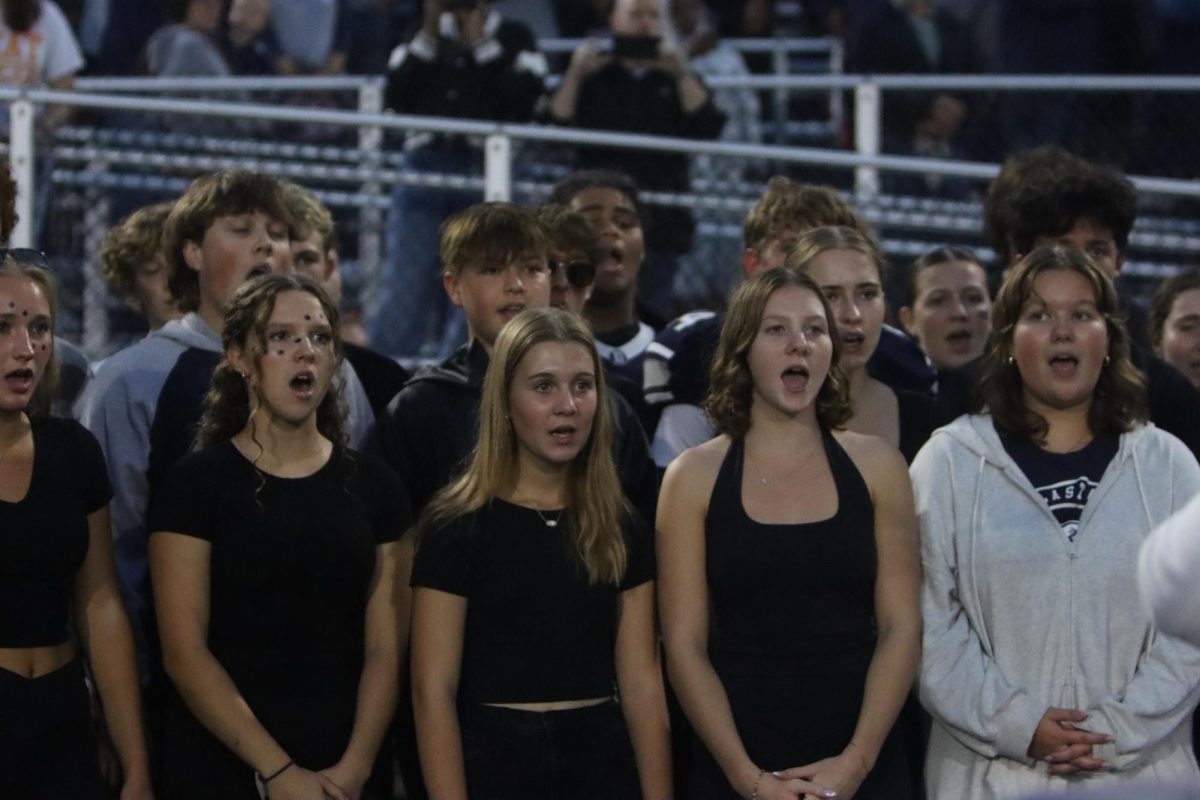 Students singing th national anthem.