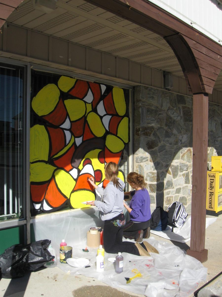 Art students painting their Halloween murals on local Dallastown businesses.