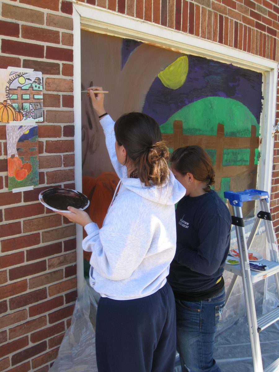 Art students painting their Halloween murals on local Dallastown businesses.