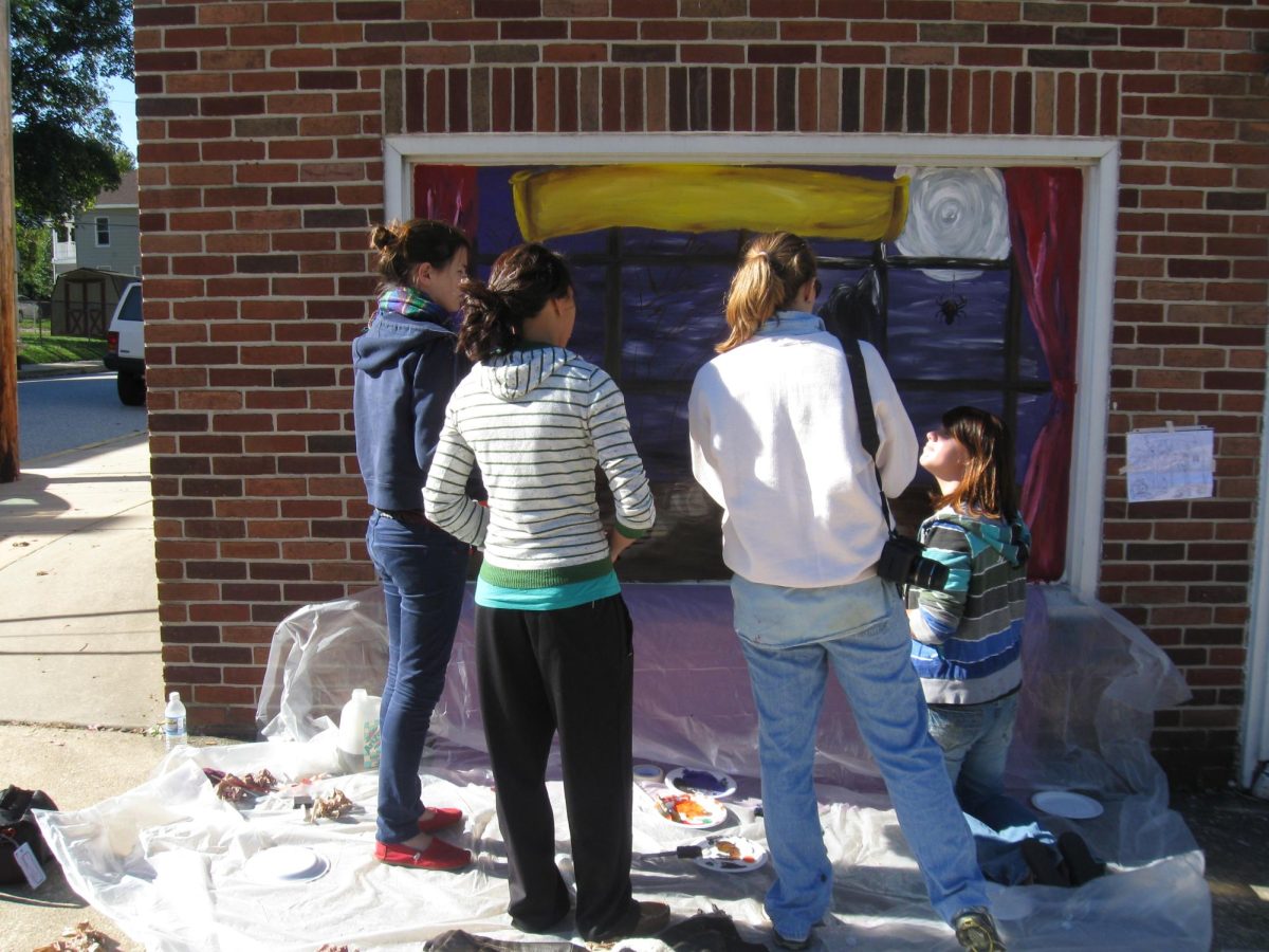 Art students painting their Halloween murals on local Dallastown businesses.