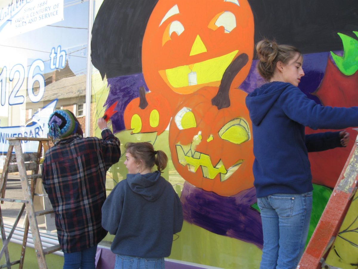 Art students painting their Halloween murals on local Dallastown businesses.