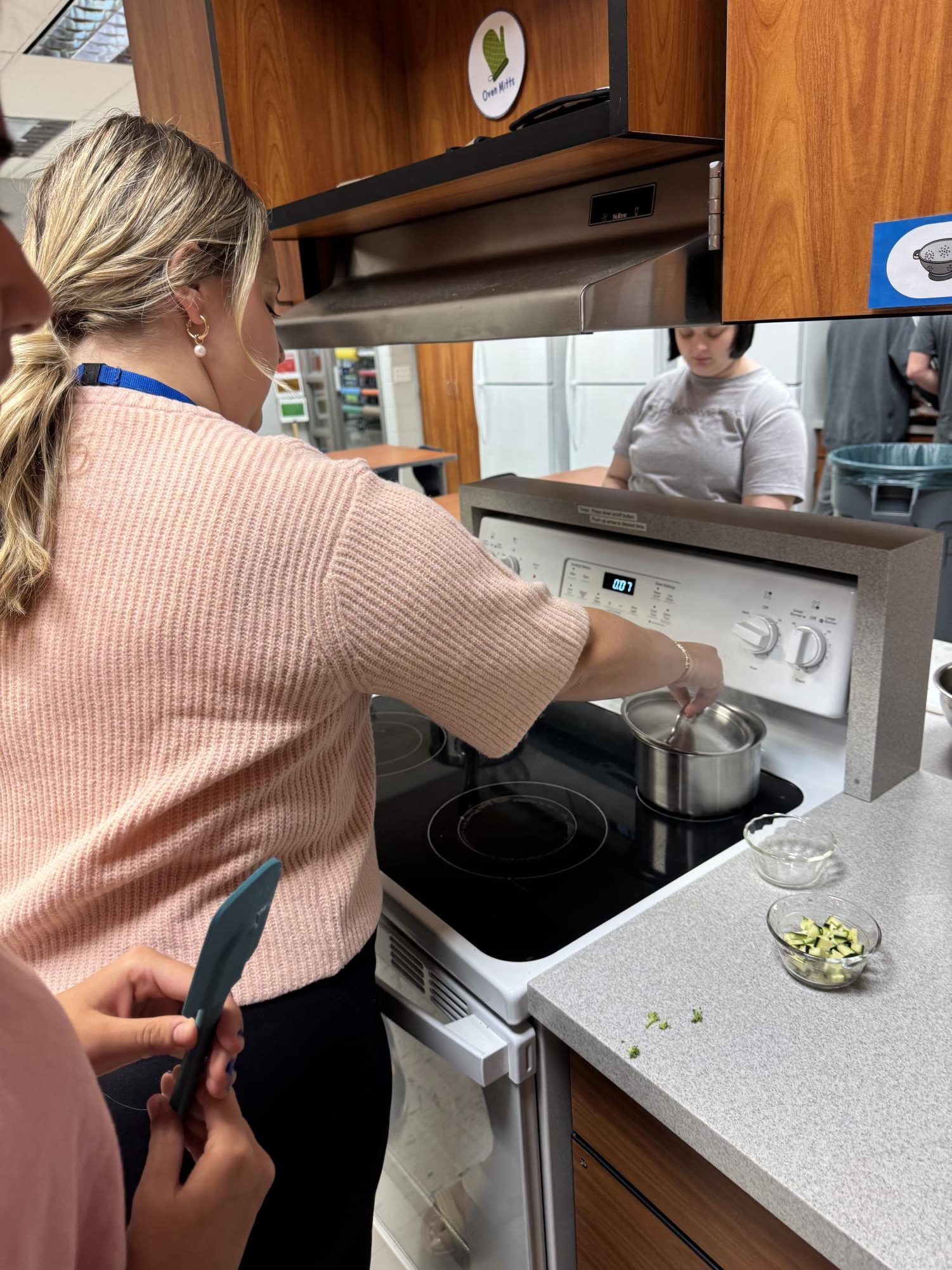 Miss Williams helps a student during a cooking lesson in her fourth period FCS class.  