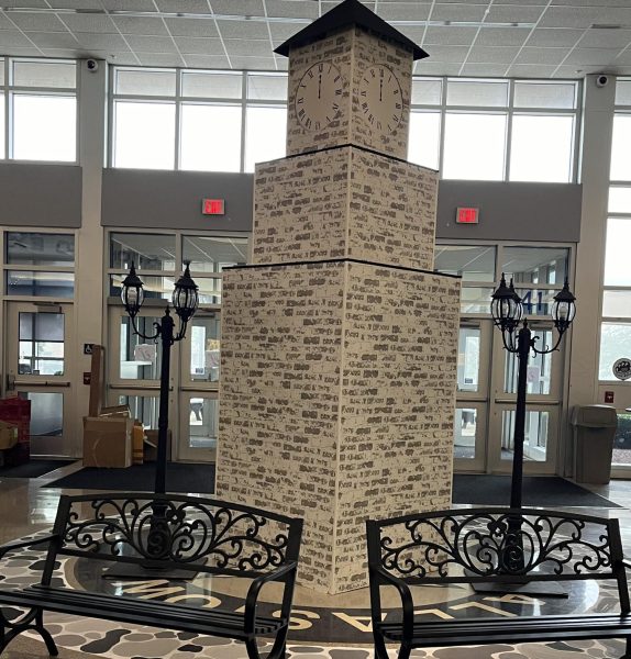 Student council worked hard on the decorations for the Homecoming dance. The impressive clock tower with the time set at Midnight to match the theme, was placed in the middle of the lobby, with benches in front where kids could sit and take pictures.