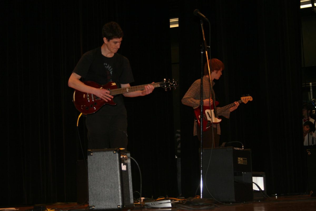 Battle of the Bands contestants playing the guitar