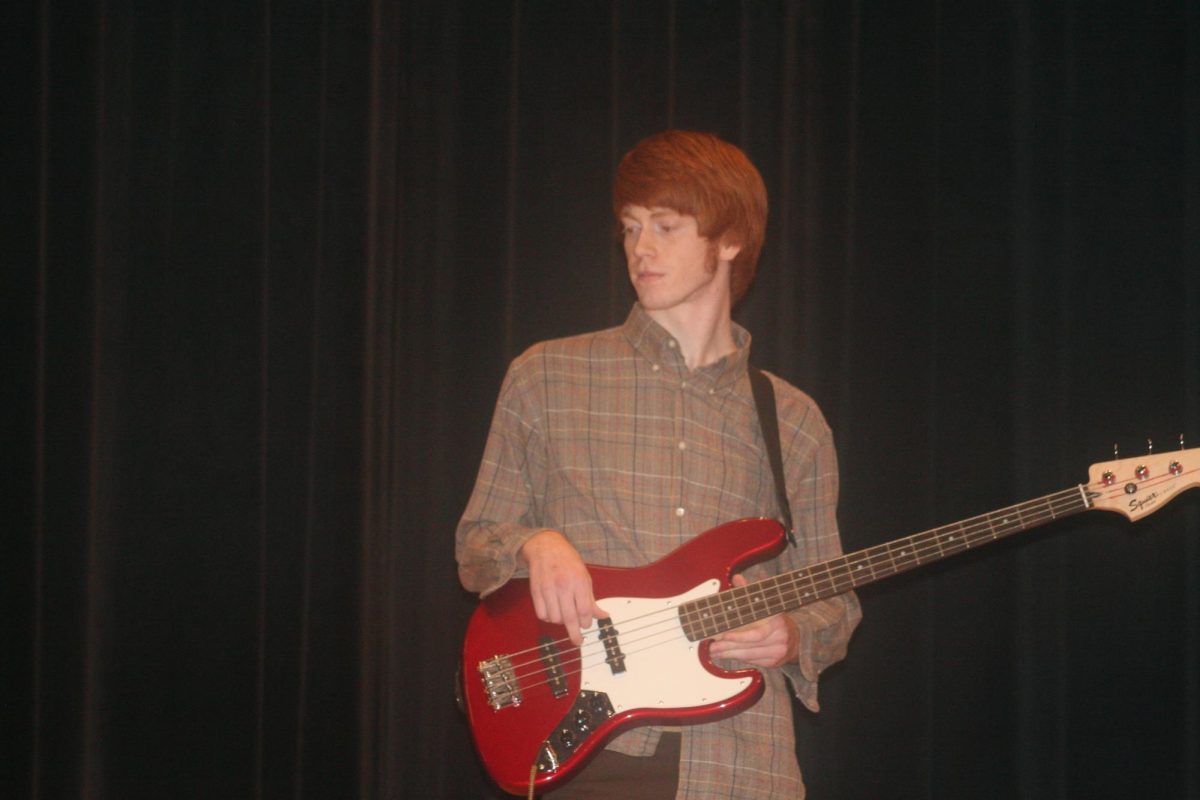 Battle of the Bands contestant playing the guitar